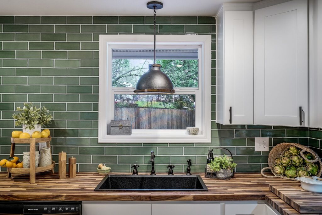 Green subway tile kitchen backsplash installed by professional tilers.